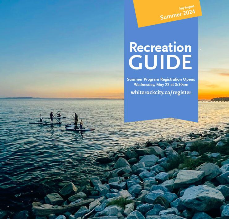 people using paddleboards on the ocean at sunset, summer recreation guide 2024