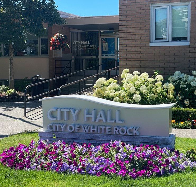 White Rock City Hall sign with purple flowers