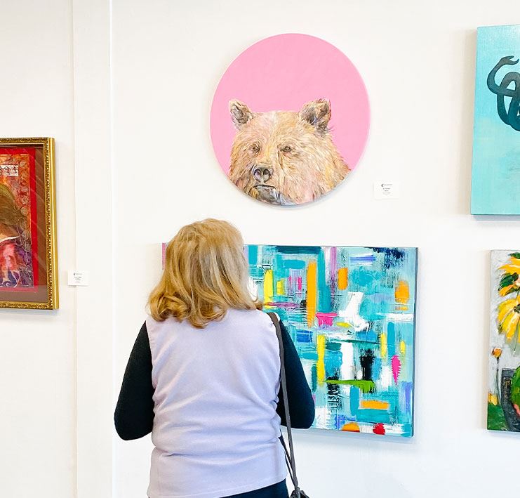 Person looking at art on a white wall