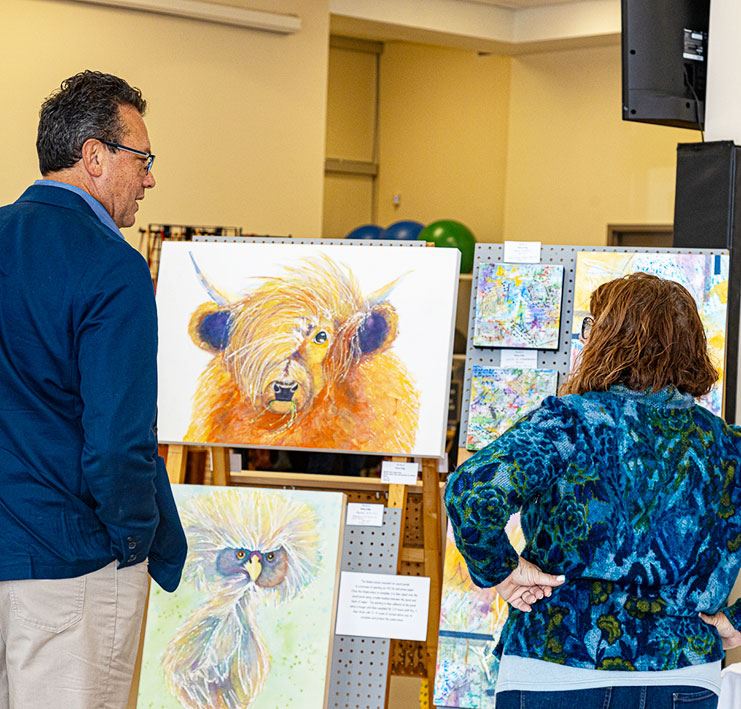 people standing and admiring artwork