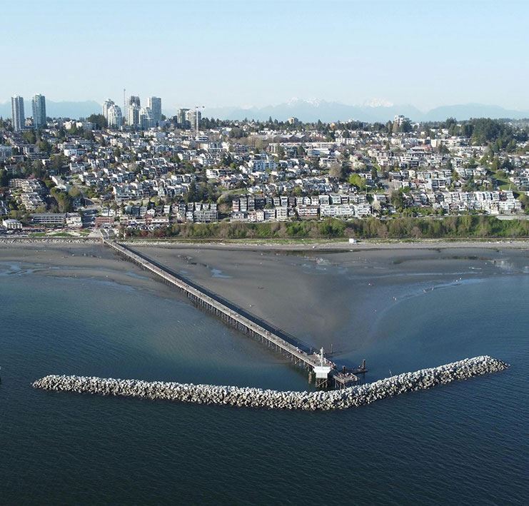 Skyline of buildings with waterfront and wooden pier, City of White Rock