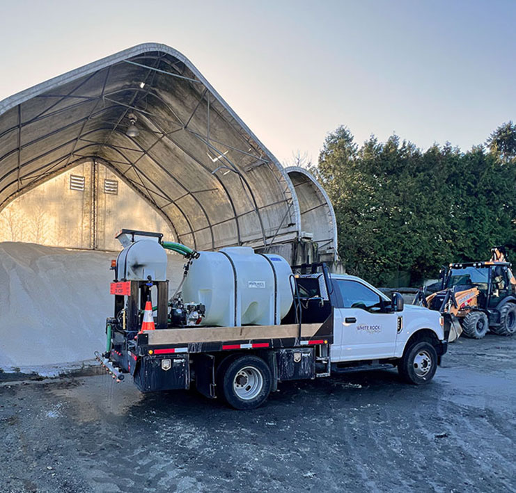 salt brining truck in front of salt mound