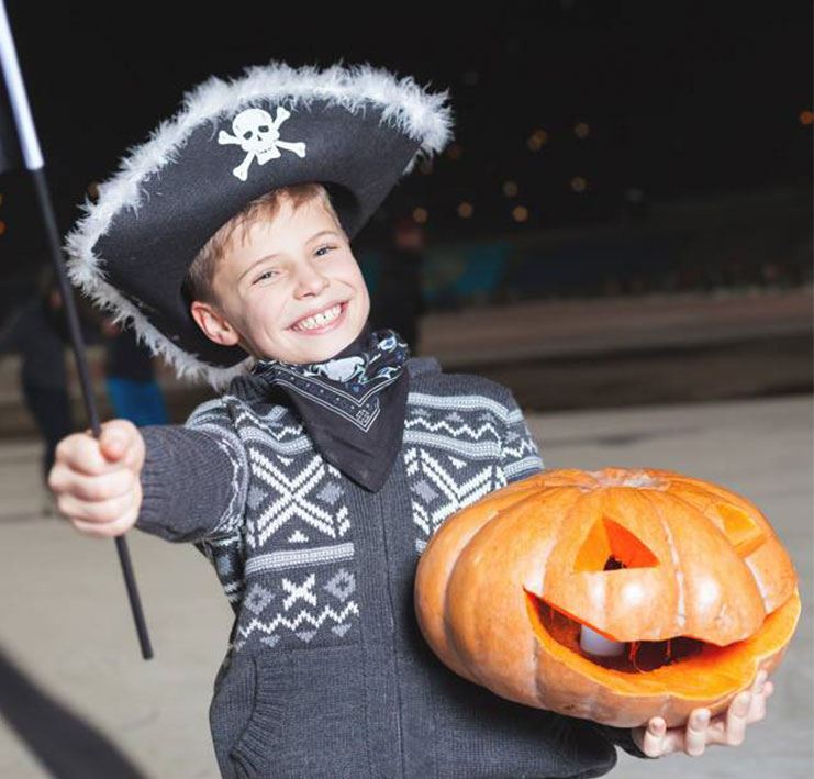 Halloween Skate - Boy dressed as a pirate holding a jack-o-lantern