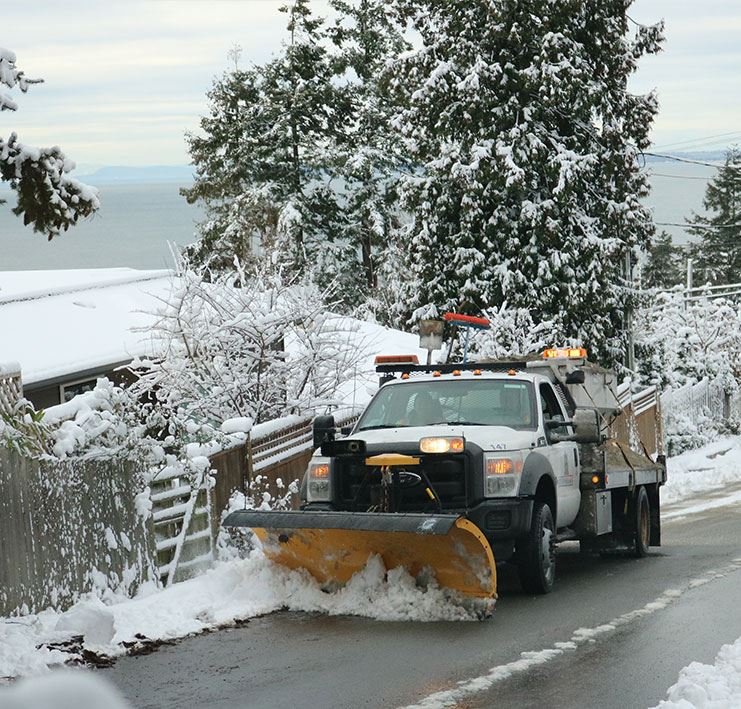 snow truck clearing snow on roadway