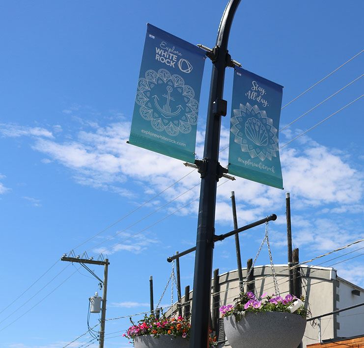 Street banners against sunny blue sky.