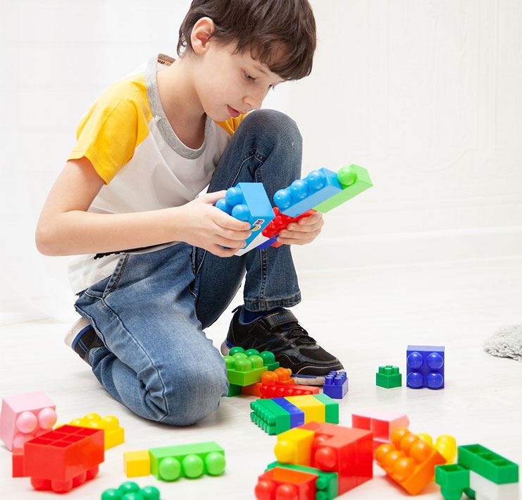 Young boy playing with LEGO