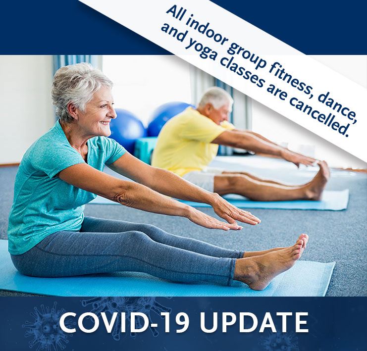 female senior sitting on yoga mat stretching - recreation classes cancelled due to COVID-19