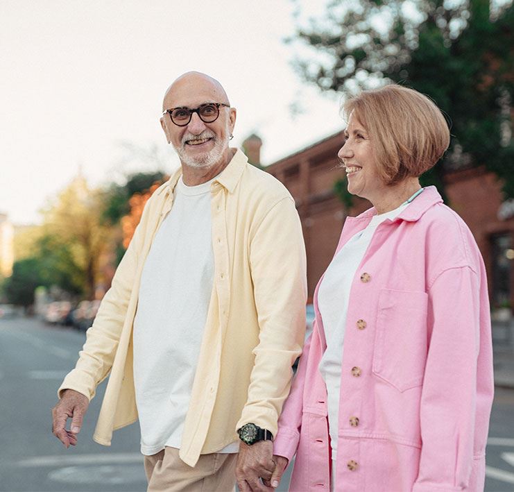 Senior couple walking holding hands