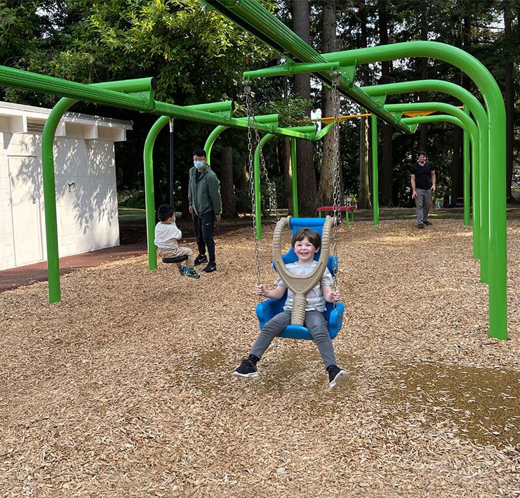 Boy playing on zipline at Generations Playground at Ruth Johnson Park