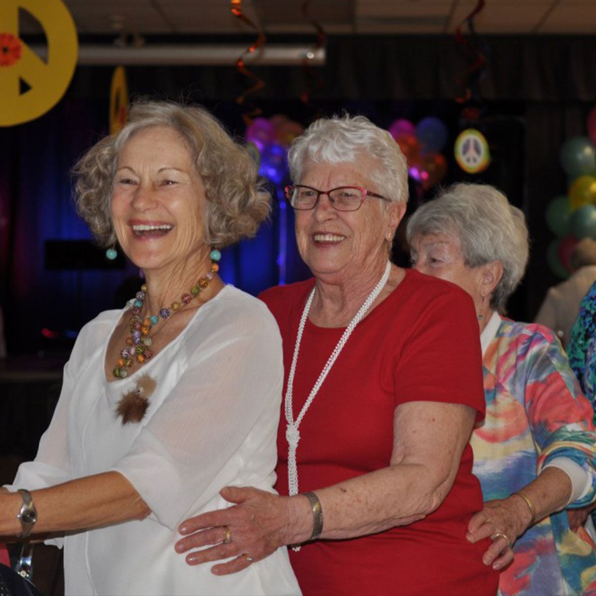 two women seniors dancing and smiling