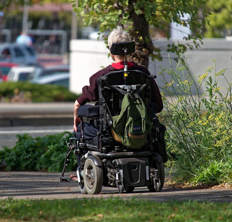 person using wheelchair using sidewalk