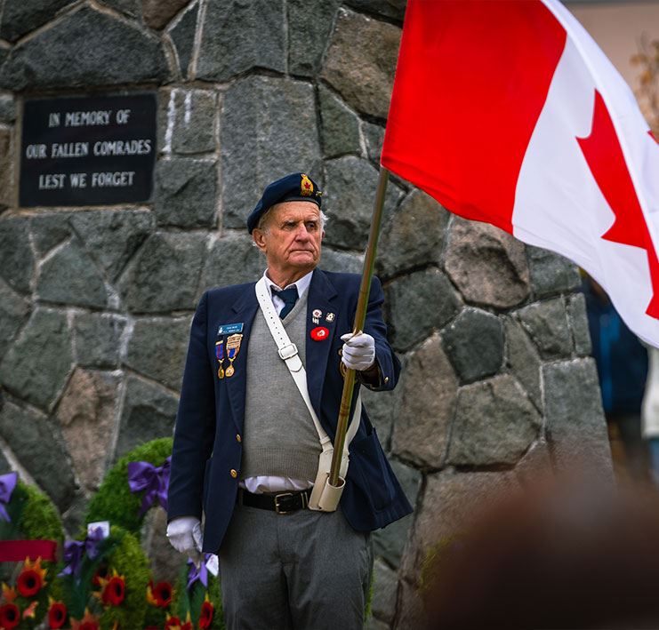Veteran holding Canadian flag.