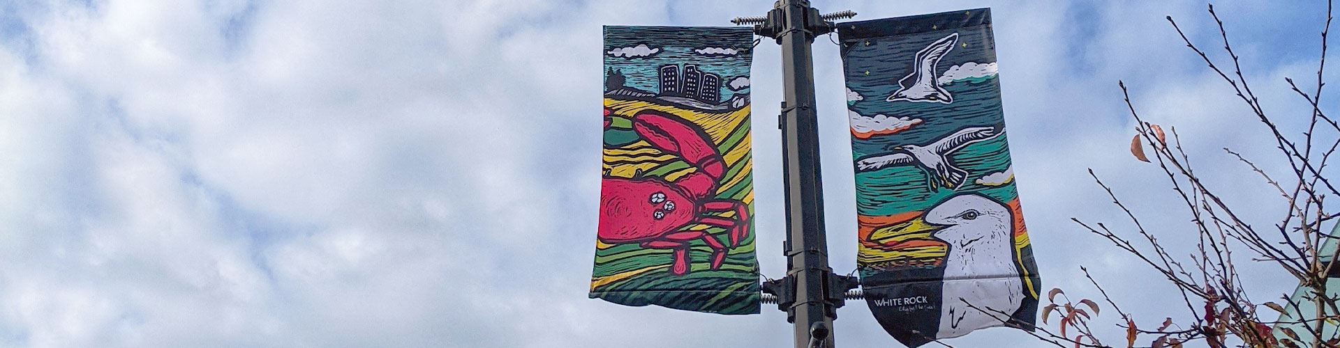 Street banners on lamp posts, art of sea gull and pink crab