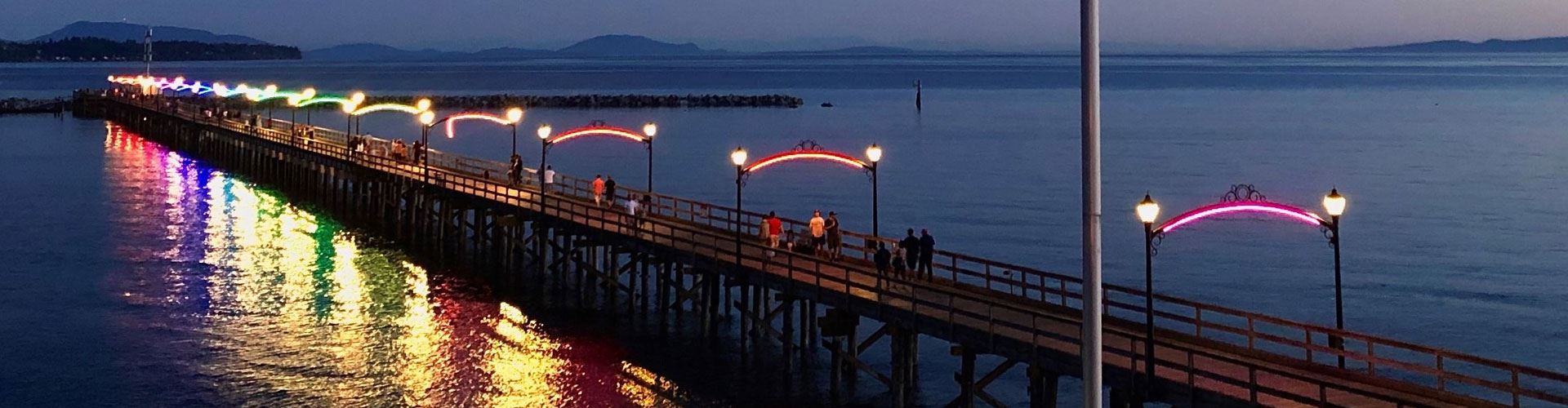 rainbow lights on pier arches at dusk