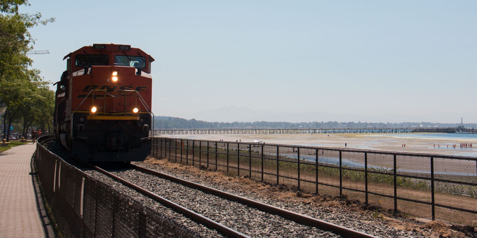 BNSF train on train tracks along ocean in White Rock