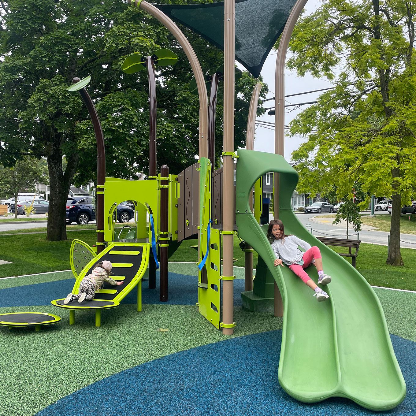 child going down slide in playground
