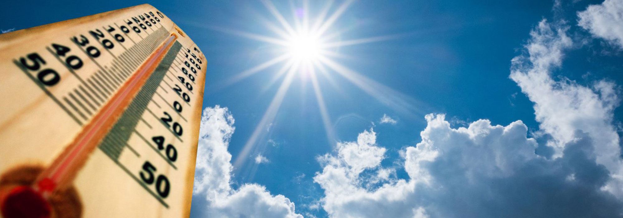 sun beaming with blue skies, high temperature on heat thermometer