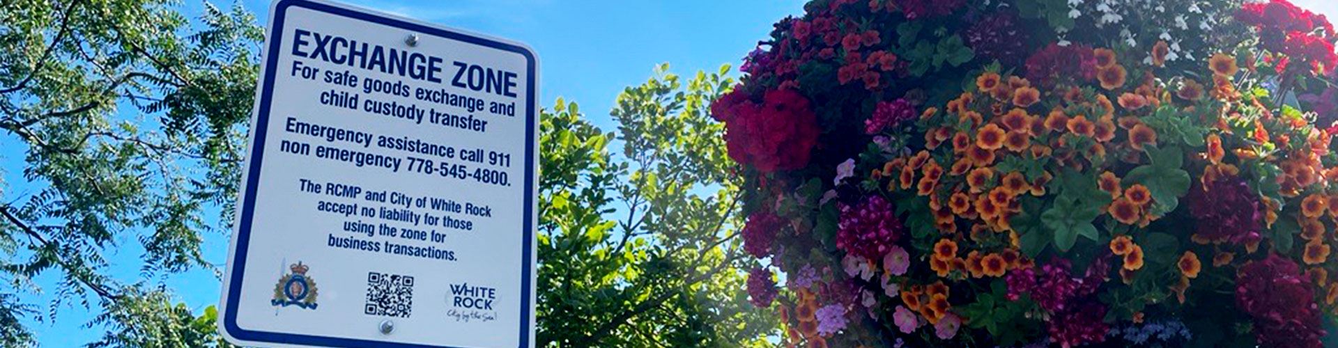 White Rock RCMP Exchange Zone sign with flower basket