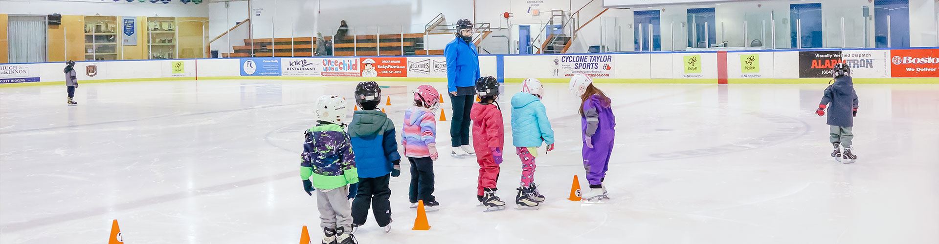 kids wearing ice skates at arena