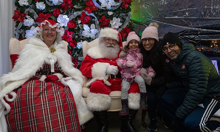 Santa & Mrs Clause taking photos with family